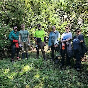 2025 January The keen workers standing in the cleared area, ready for planting.