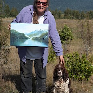 Edith Jones and her main helper Ellie receiving a gift painting from Southland Forest and Bird for her efforts over many years at Home Creek April 08.