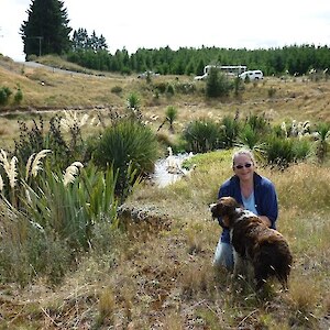 Edith Jones and Ellie with 10 year old revegetation plantings.