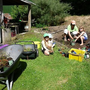 Karen, Maggie and friends potting up more plants for the nursery.