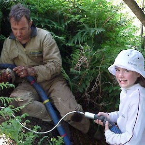 Local volunteer Libby with technical advisor Brent checking the survival of a titi nest.