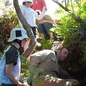 Henry helps Brent review this titi or muttonbird nest for healthy chicks to signal successful pest control efforts by local community.