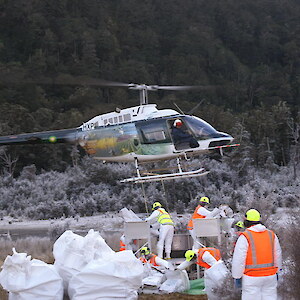 Loading bait into the hoppers on a frosty Fiordland morning.