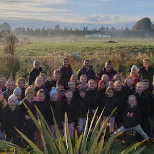 St John's Girls' School students celebrating completing a planting event at Metcalf Bush